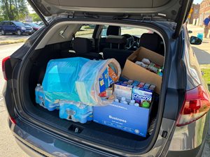 another suv with back hatch open to show a large amount of food donations