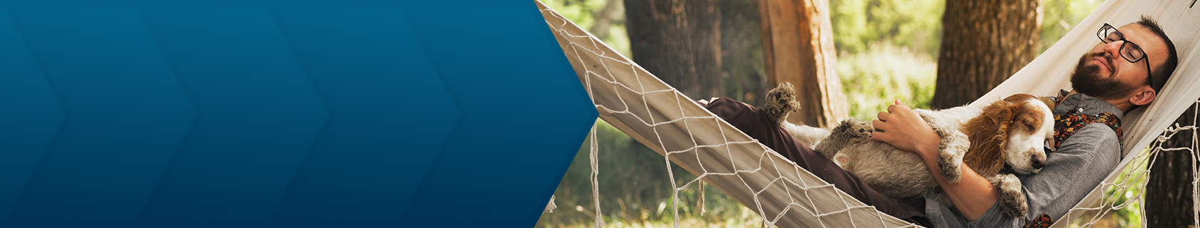 man relaxing in hammock and holding dog
