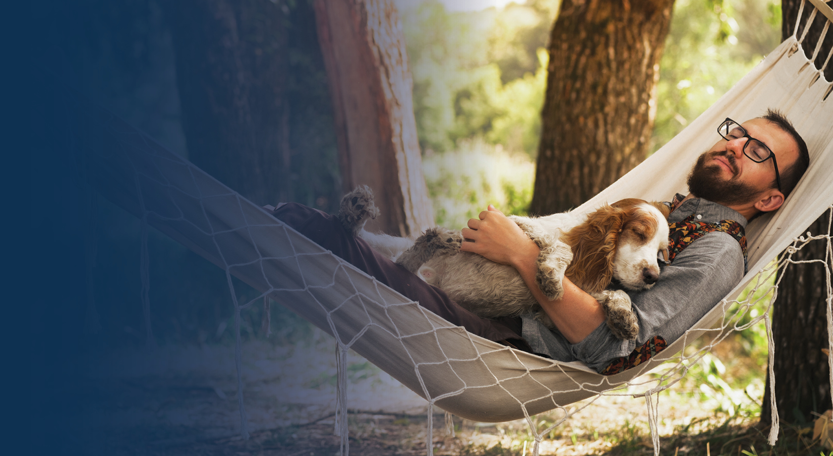 man lying on hammock with dog