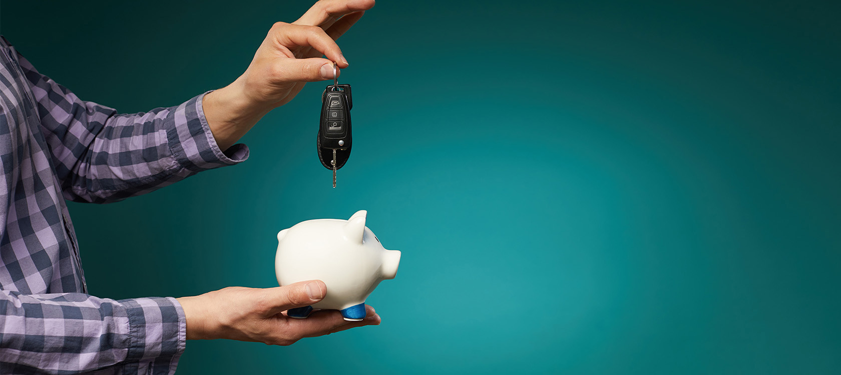 putting a car key into a piggy bank